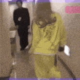 a person wearing a yellow sweatshirt with a mustache on it