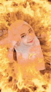 a woman in a hijab is surrounded by flames with the words assalamualaikum written below her