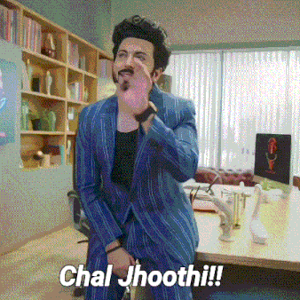 a man in a blue suit is standing in front of a desk with the words chal jhoothi written on the bottom