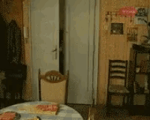 a dining room with a table and chairs and a pink balloon that says ' i love you ' on it