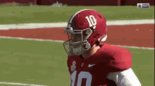 a football player wearing a helmet that says 10 on it
