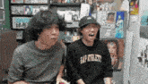 a man wearing a gap athlet shirt is laughing