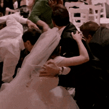a bride and groom are surrounded by their family