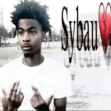 a black and white photo of a young man with sybau written in red