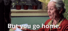 an elderly woman in a red sweater is talking to a man and says but you go home