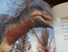 a book is open to a page with a picture of a tyrannosaurus