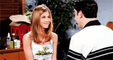 a man and a woman are sitting next to each other and smiling .