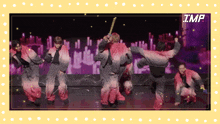 a group of people are dancing in front of a screen with the word imp on it