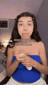 a woman in a blue top says grwm to hangout with friends