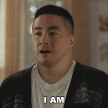 a man in a cardigan says i am