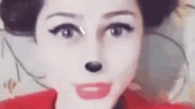 a close up of a woman 's face with a mickey mouse face .