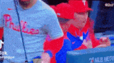 a philadelphia phillies baseball player is being interviewed by a reporter