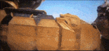 a blurred image of a person standing in front of a rock wall .