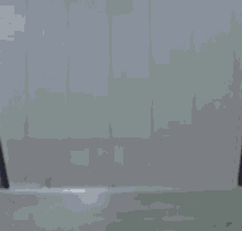 a person wearing a blue wizard hat with a crescent moon on it is standing in a dark room .
