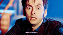 a close up of a man 's face with the words `` what was that '' written on it .