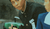 a boy in a school uniform is looking at another boy in a blue uniform .