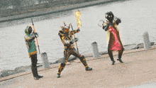 a man in a black and gold costume is holding a fire torch