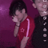 a man in a red shirt with a star on the front