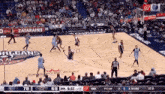 a basketball game is being played on a court with smoothie king on the floor