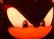 a close up of shadow the hedgehog 's face with his eyes glowing brightly .