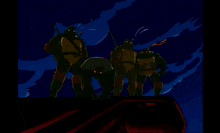 a group of teenage mutant ninja turtles standing next to each other in a dark room