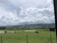 a field with a fence and a sign that says ' aoo ' on it