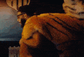 a man is wearing a fur coat that looks like a tiger 's fur .