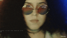 a close up of a woman wearing sunglasses with a watermark that says gang 16/50 on the bottom