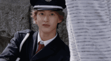 a man in a police uniform is leaning against a wall with the letters rns on the bottom