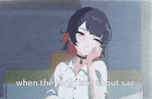 a girl with purple hair is sitting on a couch with her hand on her face .