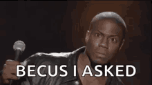 a man in a leather jacket is holding a microphone and saying becus i asked .