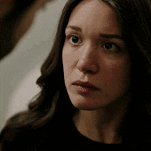 a close up of a woman 's face with her eyes closed