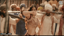 a woman is dancing in front of a group of men with the words pranay varma on the bottom