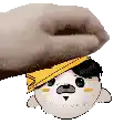 a hand is holding a cartoon character 's head with a hat on it .