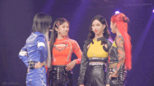a group of girls are standing next to each other on a stage and one of their shirts says white