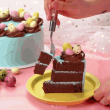 a person is cutting a slice of chocolate cake with easter eggs on top