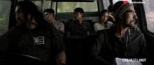 a group of people are sitting in a van with the words terbaik ke langit on the bottom right