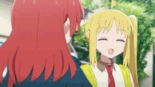 a girl with red hair and a girl with blonde hair are talking to each other .