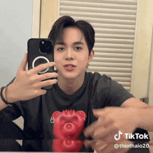 a man is taking a picture of himself in a mirror with a tik tok watermark