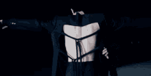 a man in a suit is standing next to another man in a black suit