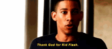 a close up of a man 's face with the words `` thank god for kid flash '' written on it .