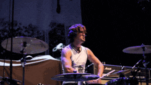 a man playing drums with a shirt that says ' i love you ' on the front