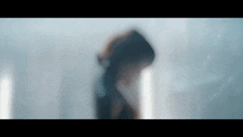 a blurry picture of a person with a hood on