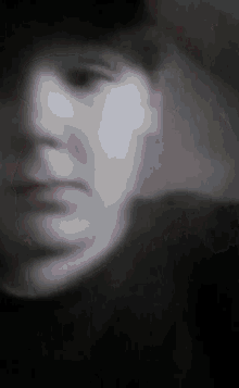 a blurry picture of a person 's face with a hat on