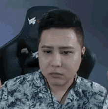 a man wearing headphones is sitting in a chair .
