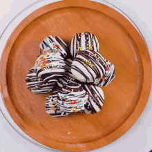 a wooden plate topped with chocolate covered cookies and sprinkles says easy plus