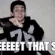 a blurry picture of a man with the words `` eeeet that s '' written on the bottom .
