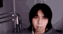 a person wearing headphones looks at the camera