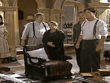 a group of people are standing in a living room