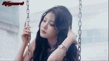 a woman sitting on a swing with a gifsaespa watermark on the bottom